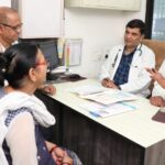 Woman in a consultation discussing PCOS PMOS symptoms with a doctor
