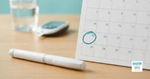 Once a week insulin pen and a calendar with one day marked, showing a weekly insulin injection